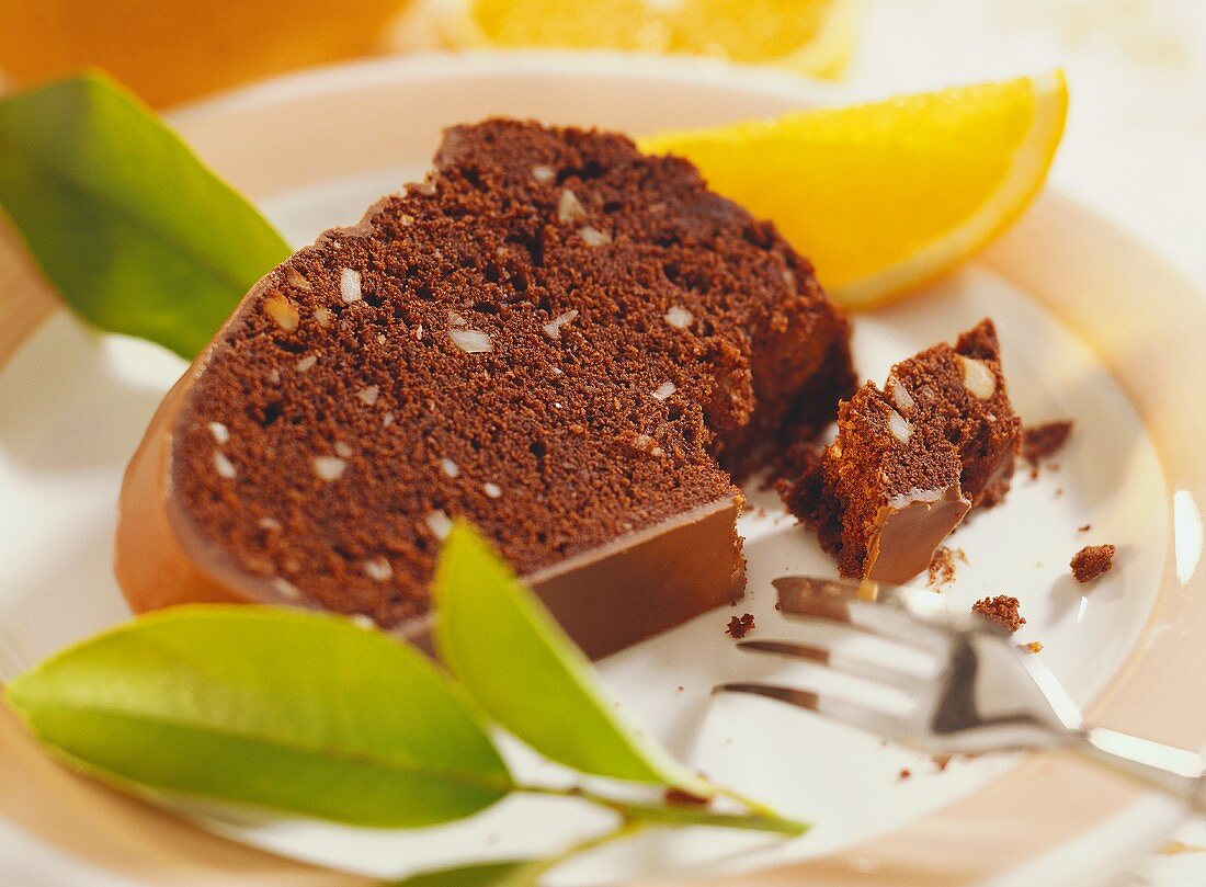 A piece of chocolate orange fruit cake on plate