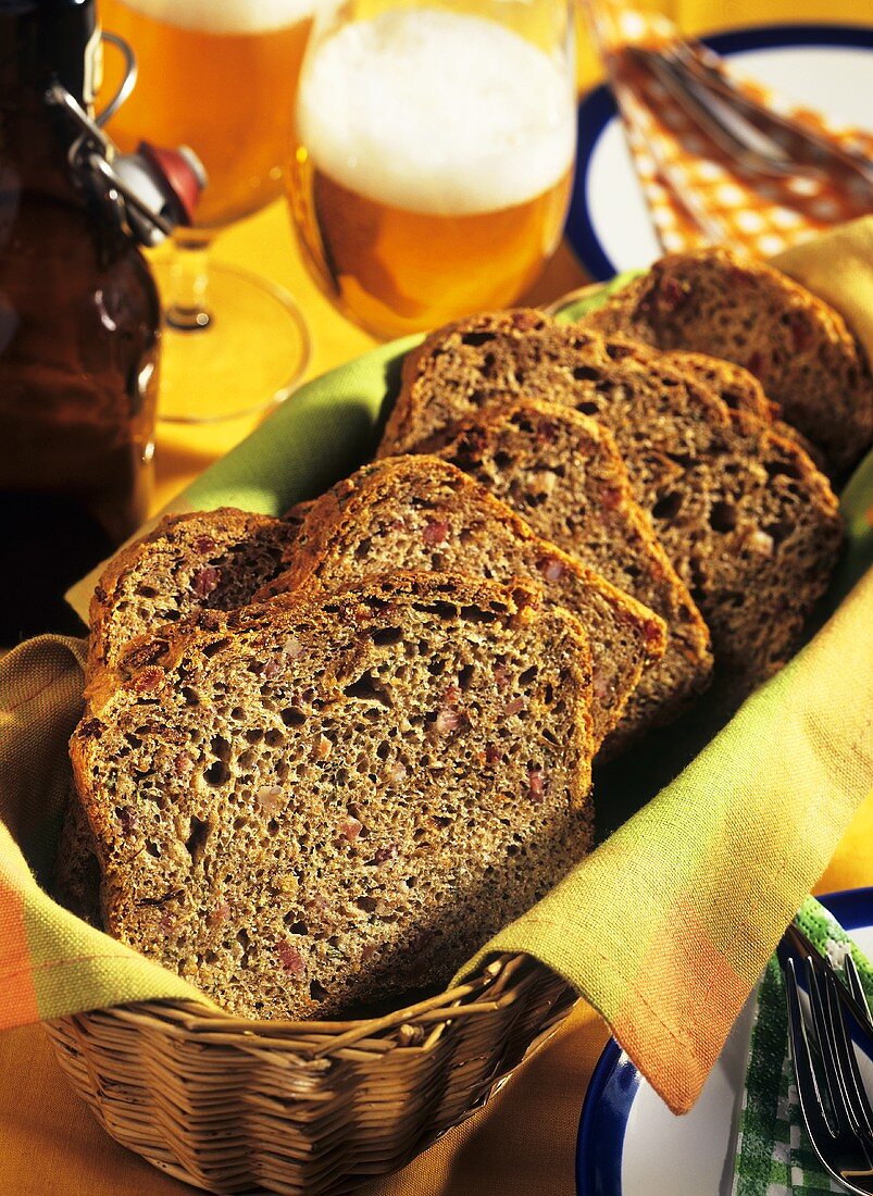 Sliced party loaf in bread basket; beer