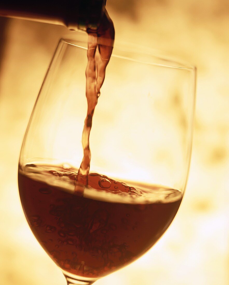 Pouring red wine into a glass