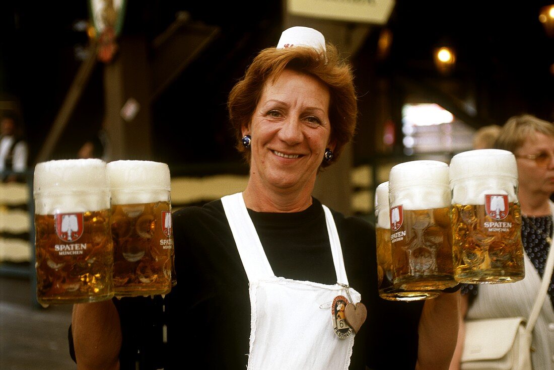 Waitress with full tankards of beer at Oktoberfest