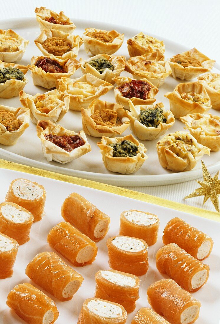 Salmon rolls and filled filo pastry snacks