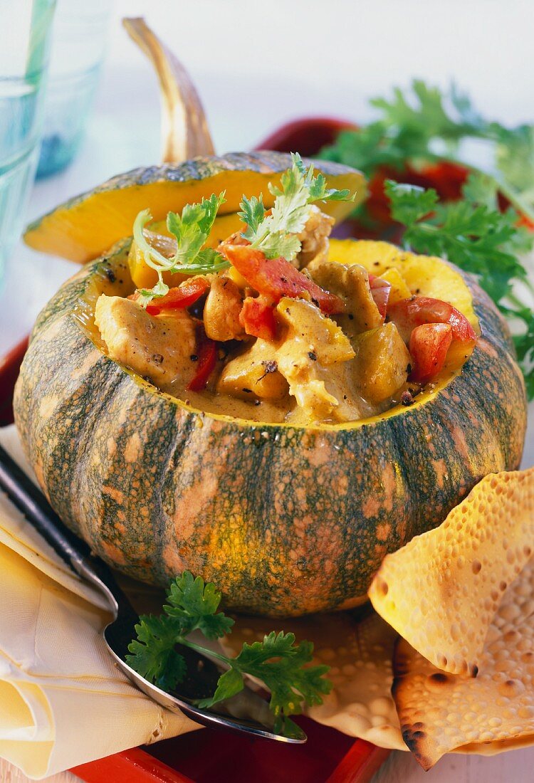 Pumpkin curry with chicken & peppers in hollowed-out pumpkin