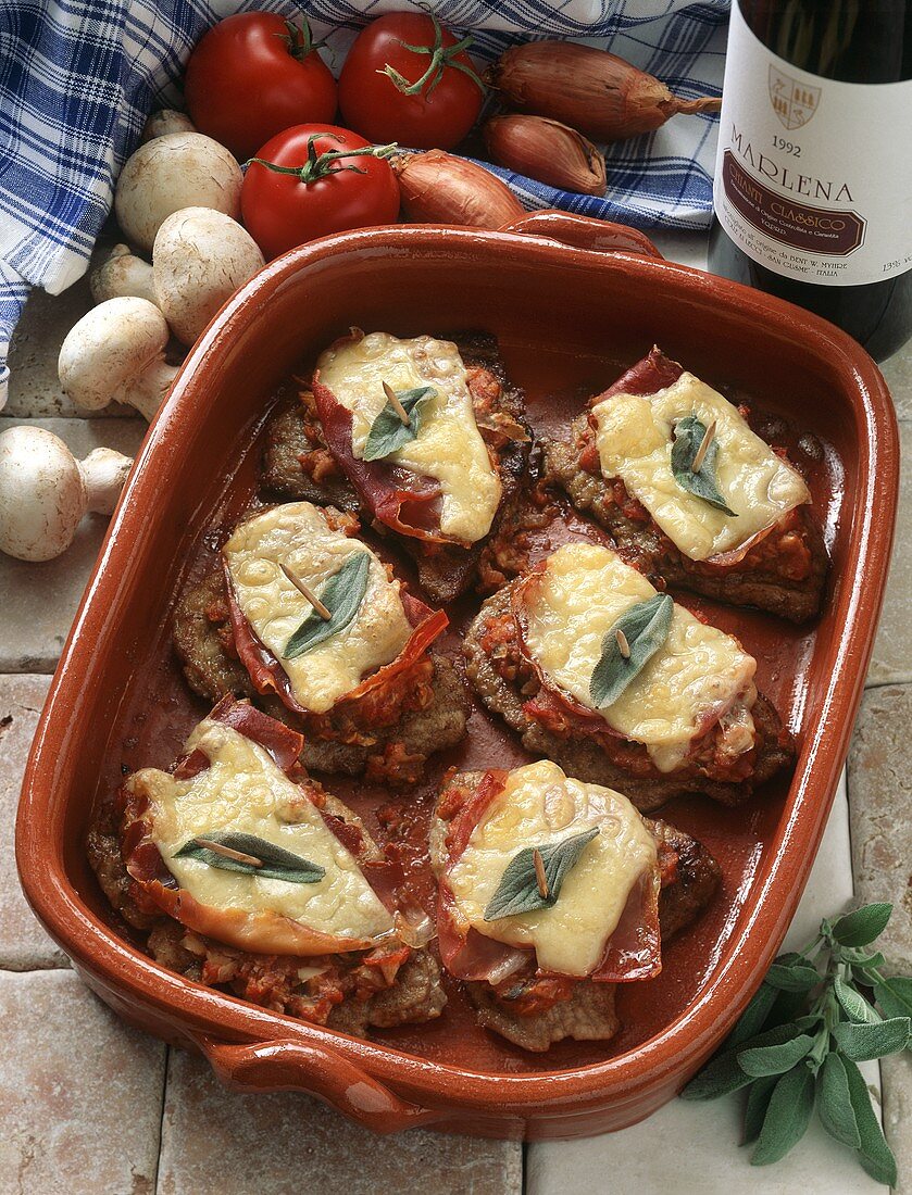 Veal escalope with ham, cheese and sage in baking dish