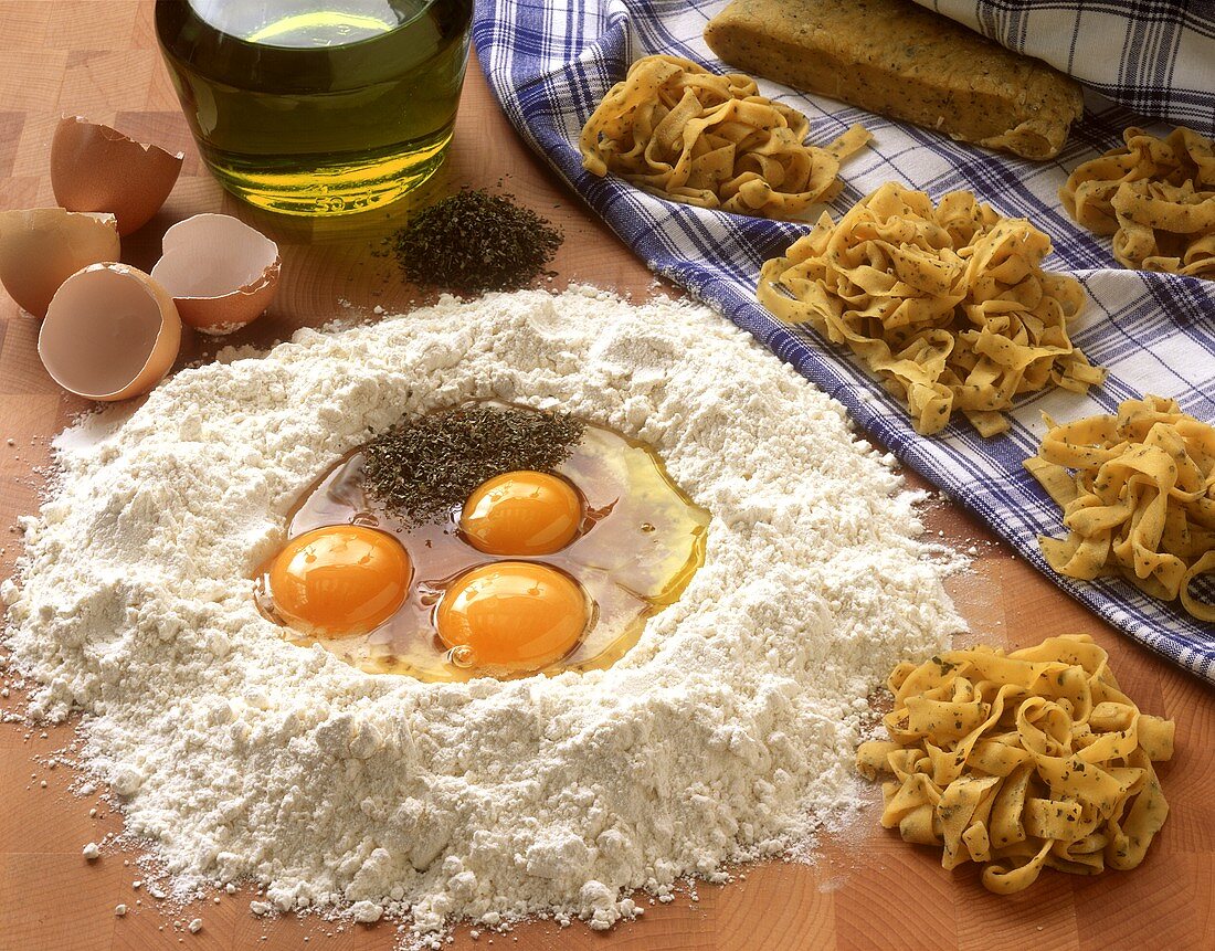 Home-made pasta & ingredients (flour, eggs, olive oil)