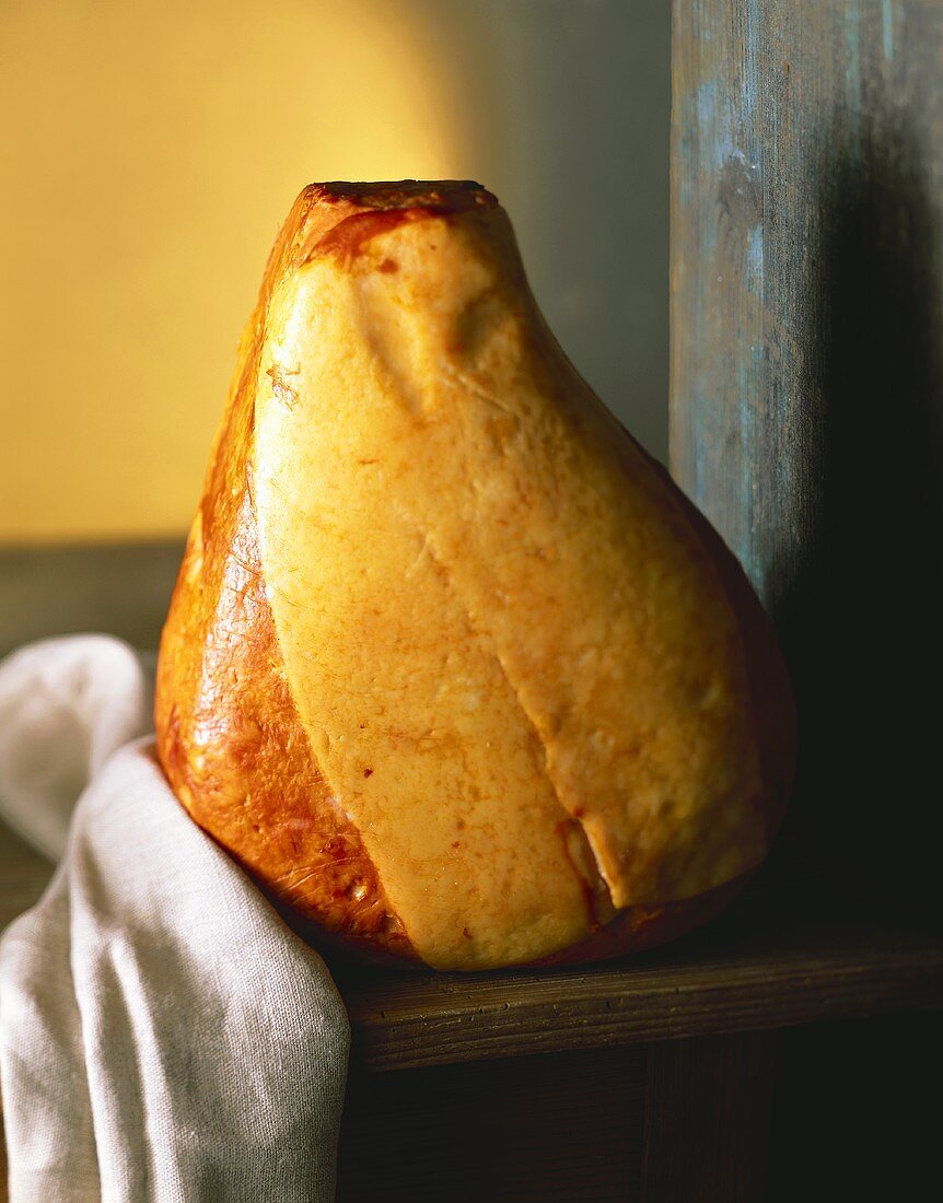 Whole ham on wooden table