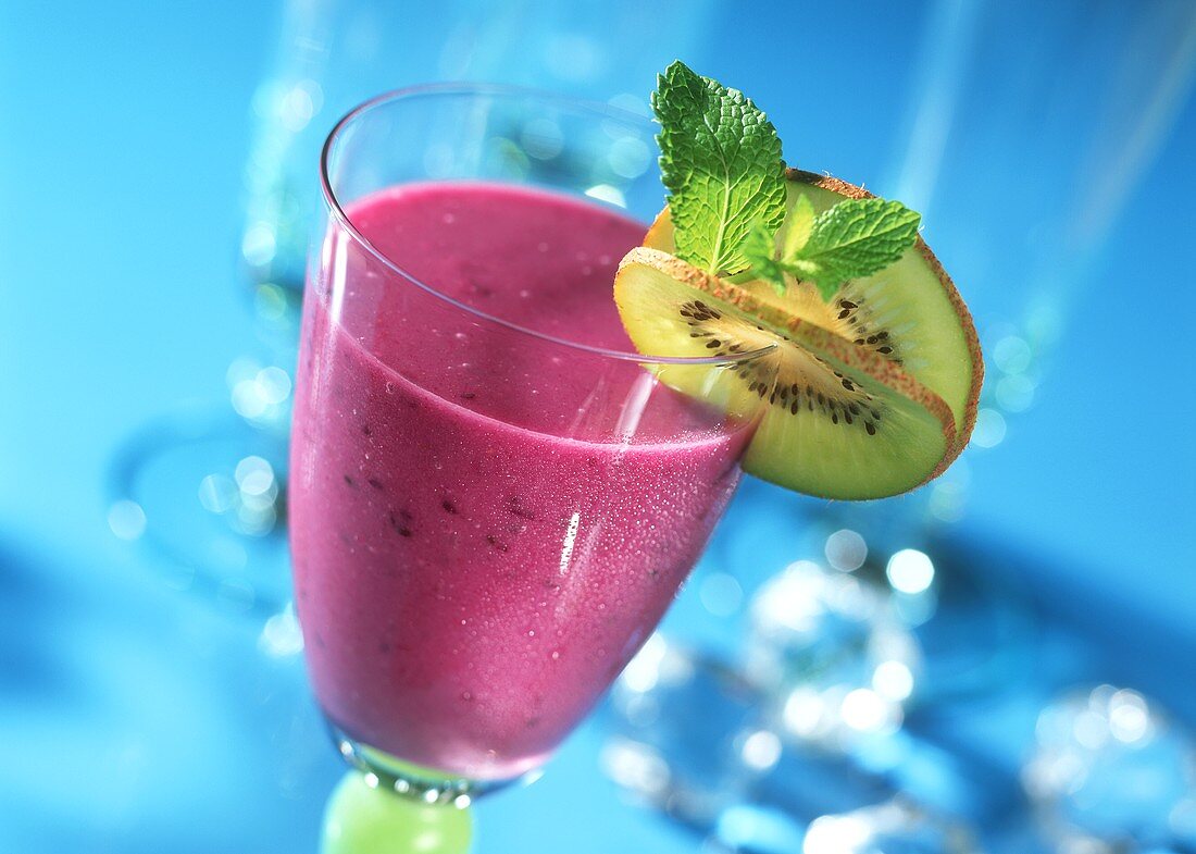 Blueberry drink with kiwi slice and fresh mint