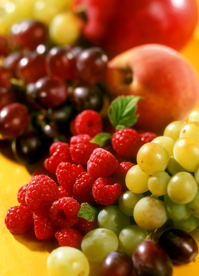 Various types of fruit (grapes, raspberries, peach)