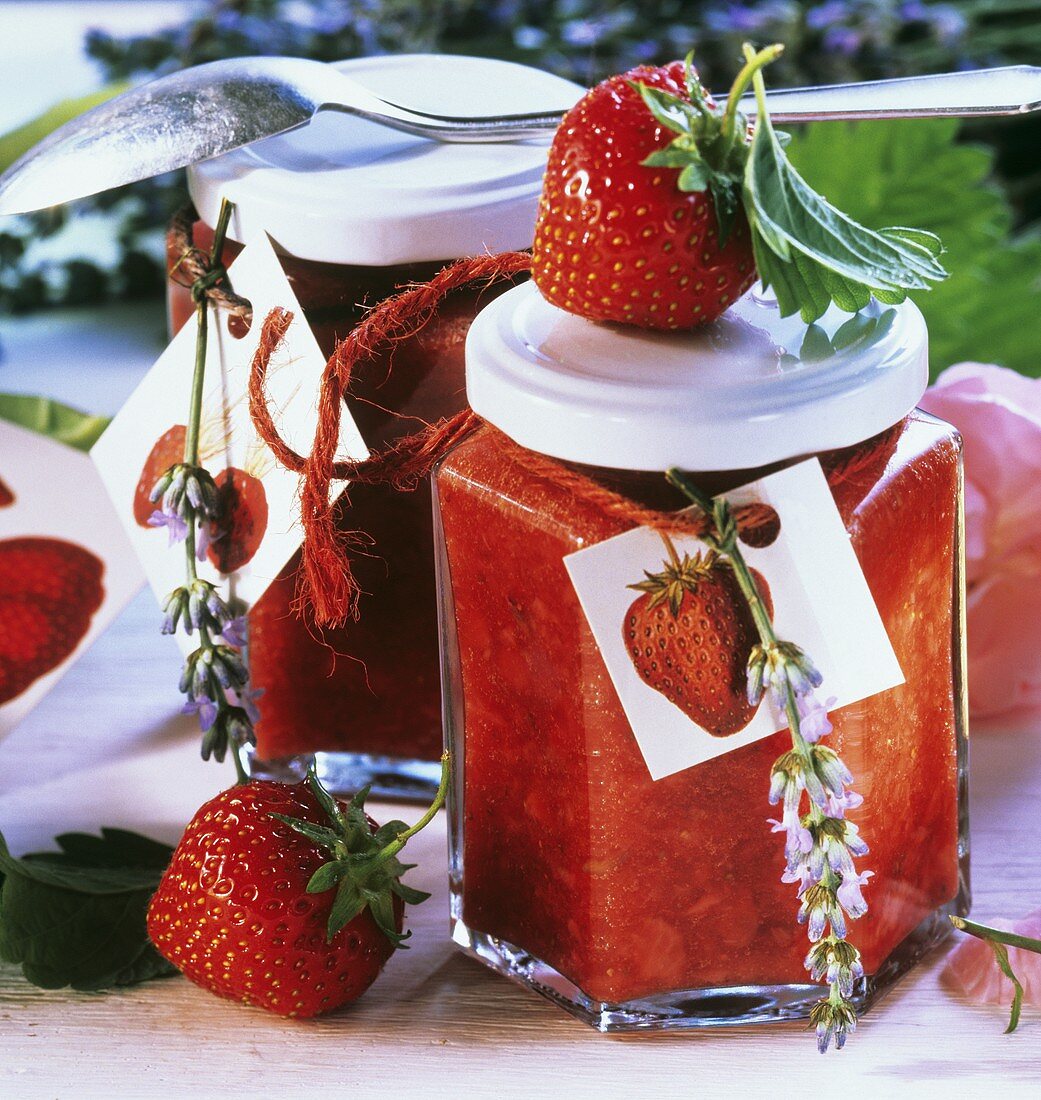 Strawberry preserve in jam jars decorated with lavender