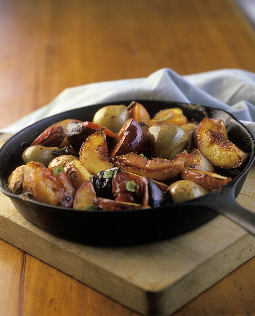 Baked fruits in a pan on a chopping board