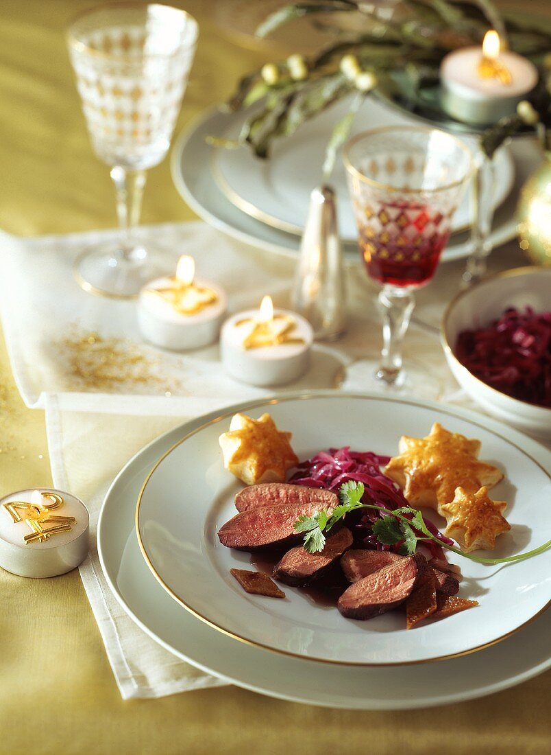 Poached duck breast in red wine sauce with puff pastry stars