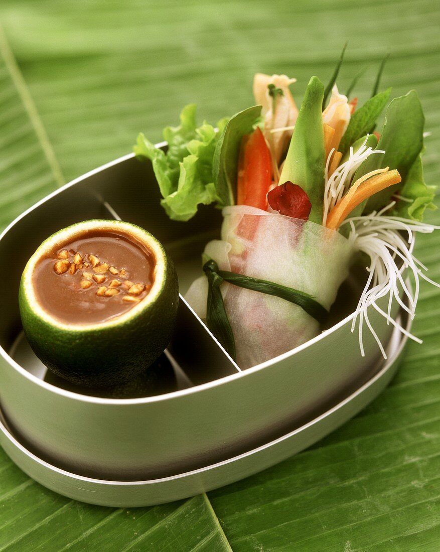 Vegetables in rice paper parcel with peanut dip