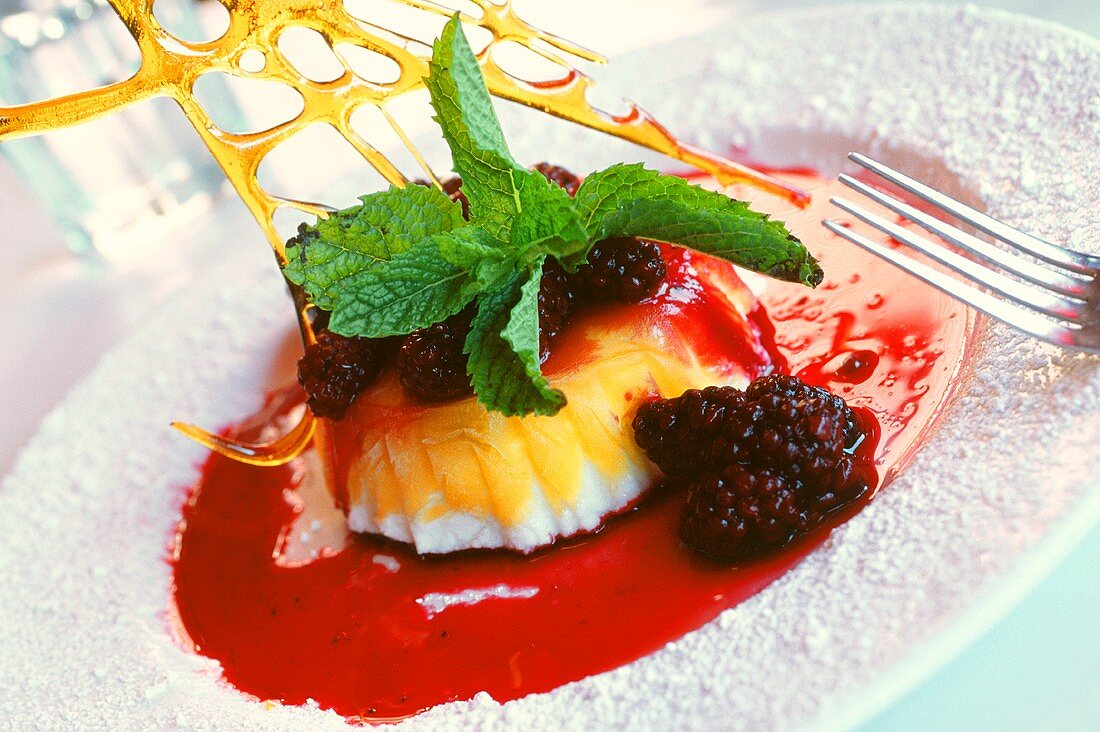 Frozen mango soufflé with blackberry sauce and mint