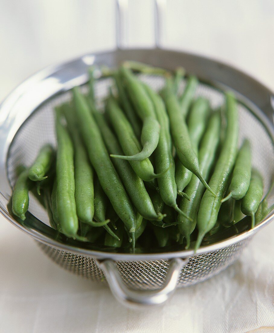 Fresh green beans in a strainer