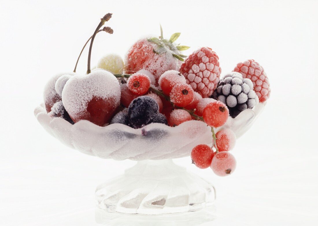 Frozen cherries and berries in a glass bowl