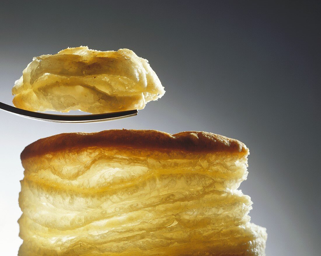 Puff pastry with a piece on a fork