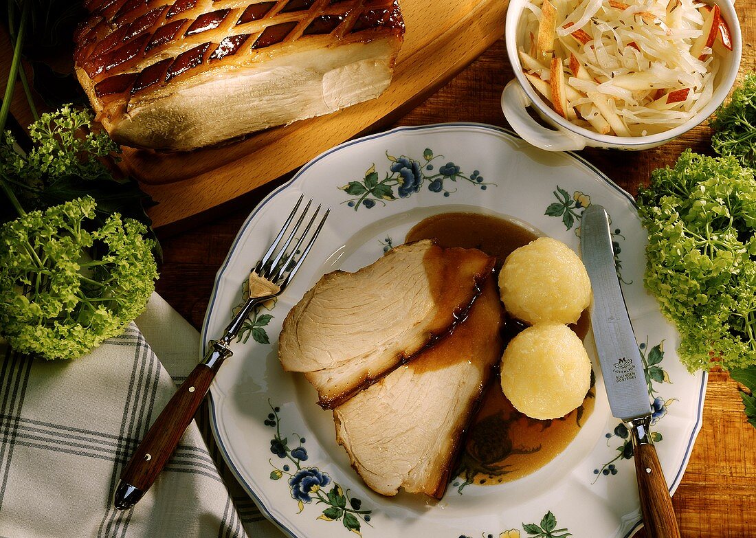 Roast pork with potato dumplings and cabbage salad