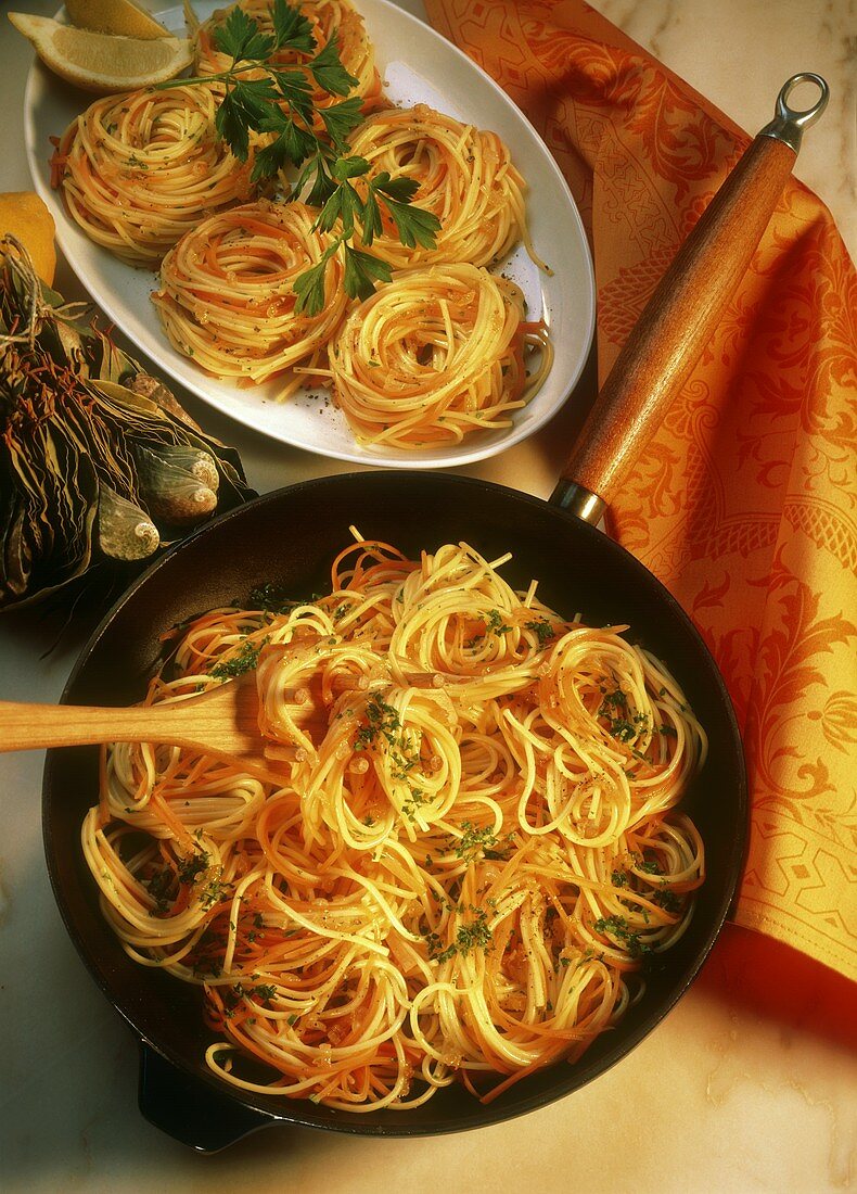 Pasta nests with carrots in pan and on platter