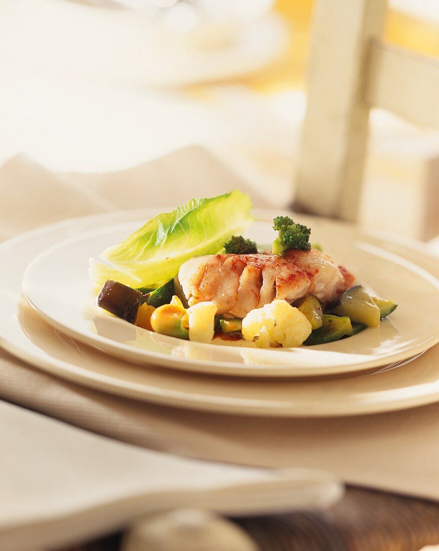 Grouper fillet with peppers and vegetables on plate