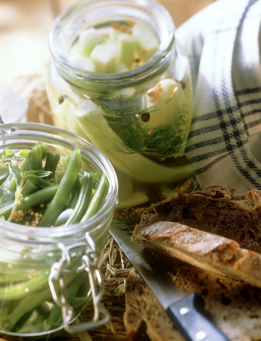 Spiced beans and mustard gherkins in jars; Peasant bread 