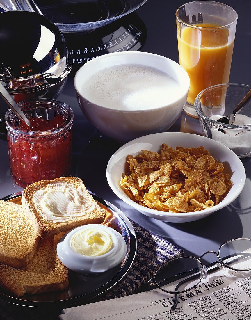 Breakfast with cornflakes, toast, jam and orange juice