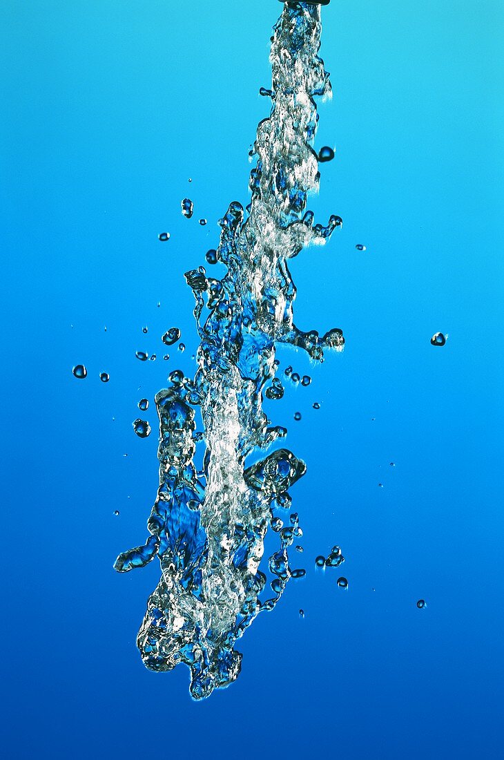 Jet of water against a blue backdrop