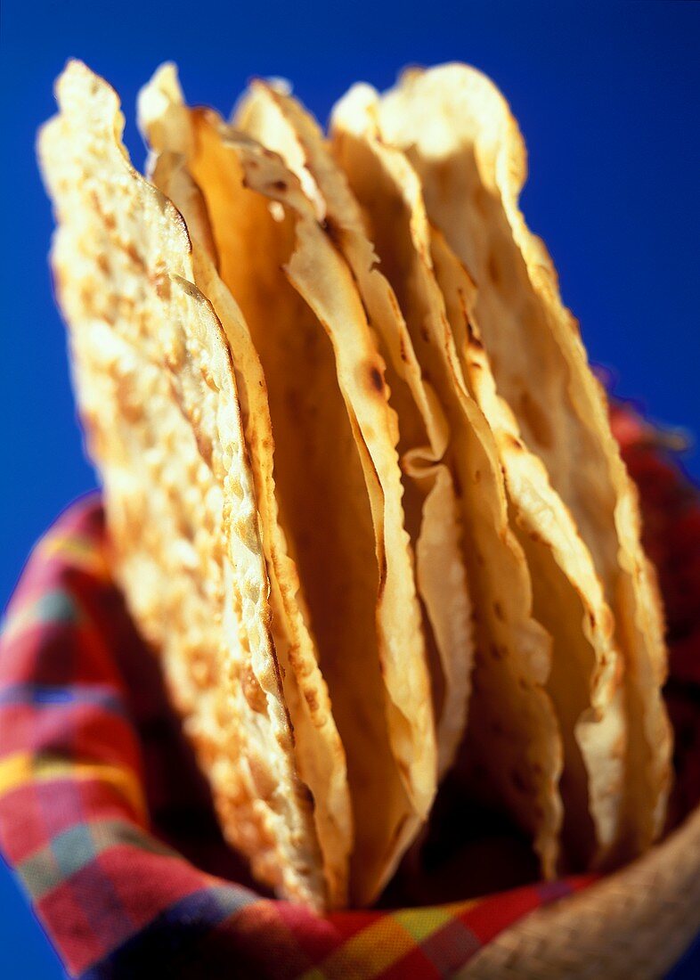 Wheat tortillas in a bread basket