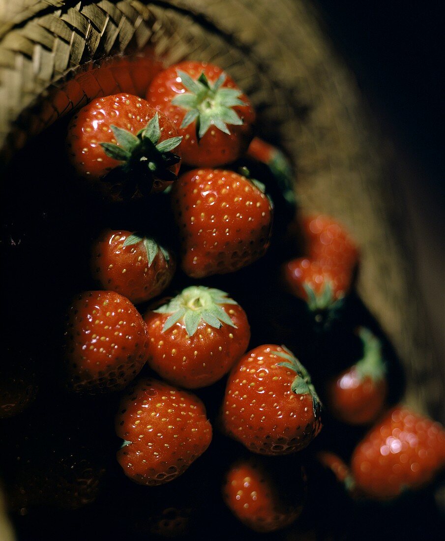 Fresh strawberries in a straw hat