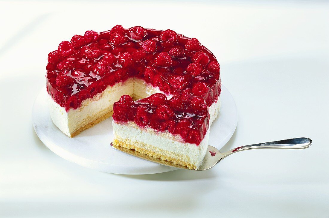 Raspberry cream gateau with piece on cake slice