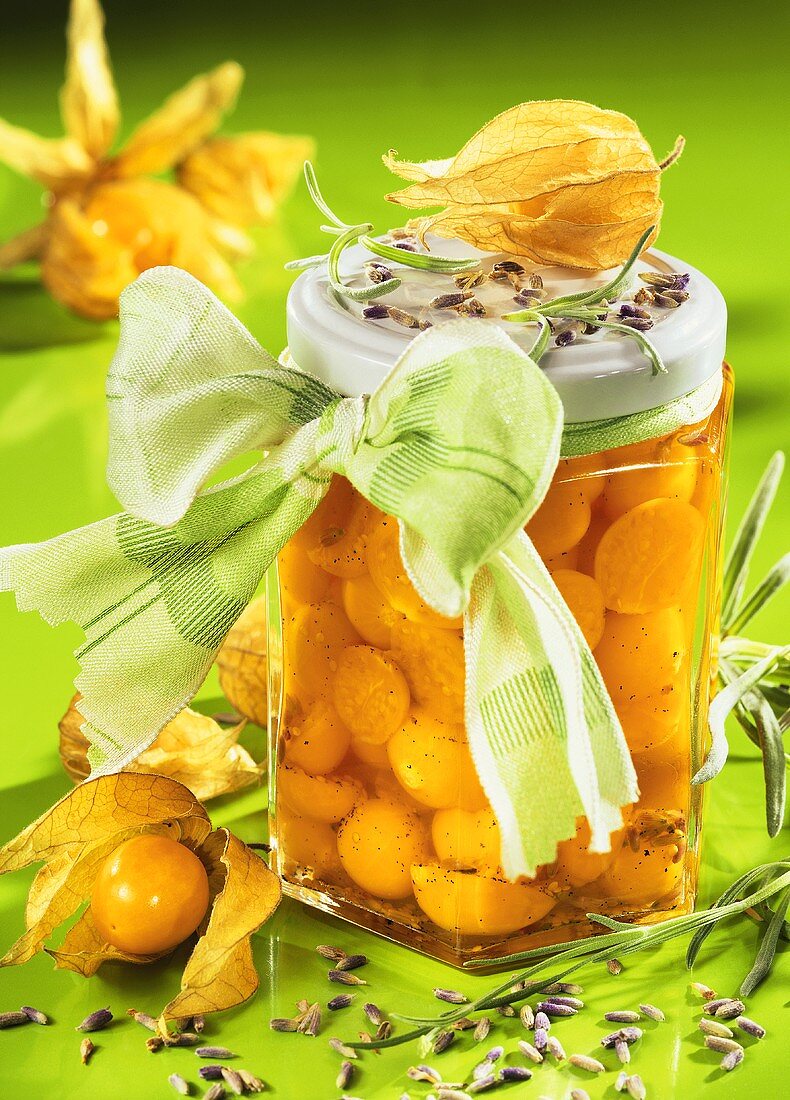 Physalis compote with lavender in preserving jar with bow