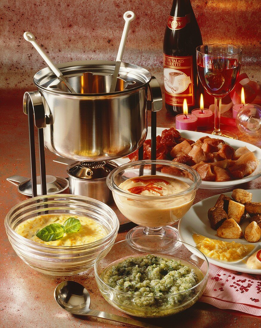 Meat fondue with three dips and wine