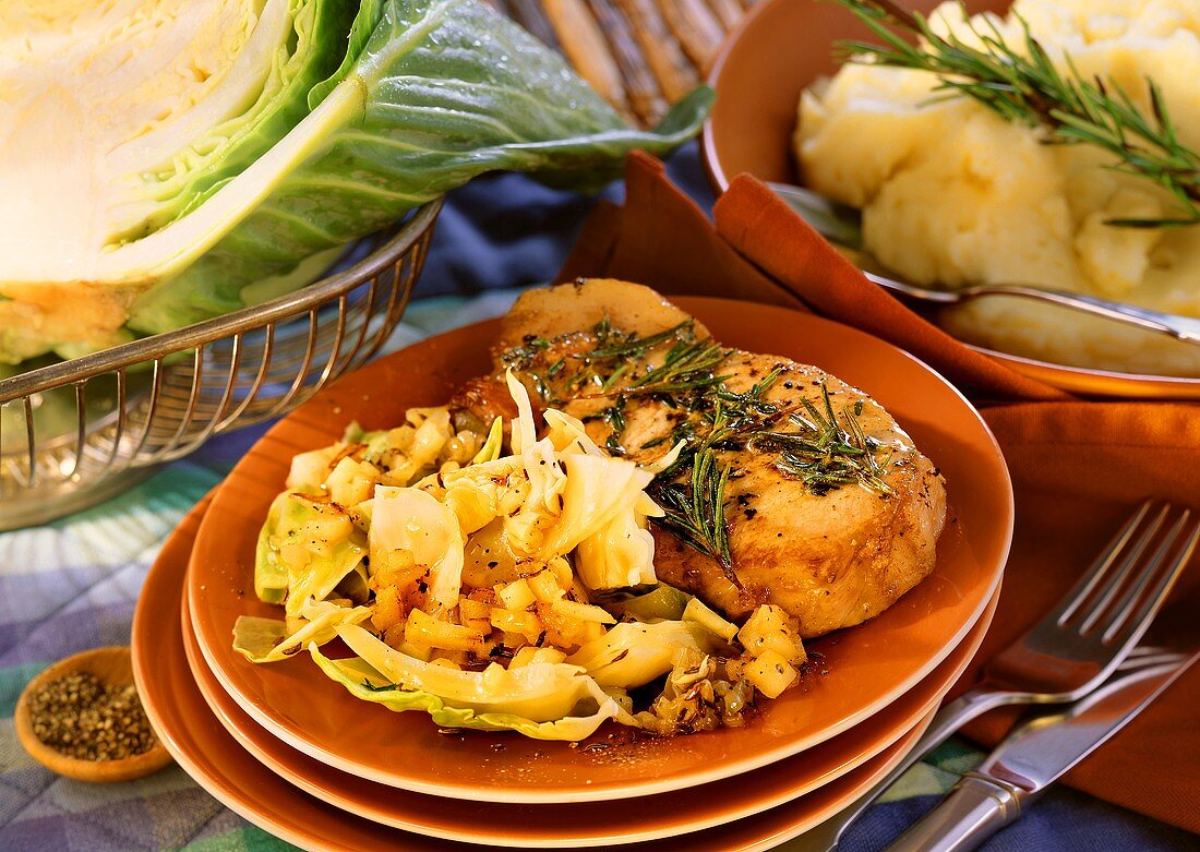 Pork cutlet with white cabbage on plate; mashed potato