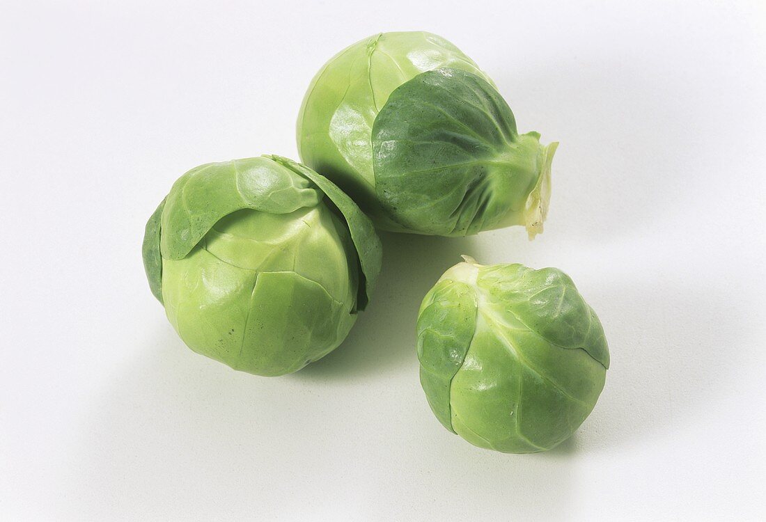 Three Brussels sprouts on white background