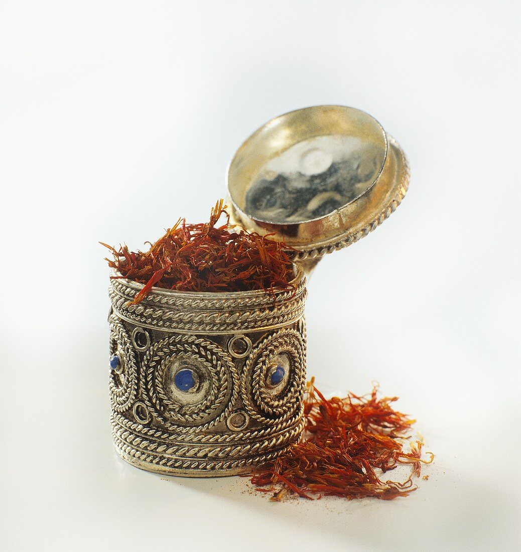 Saffron threads in a silver box and beside it