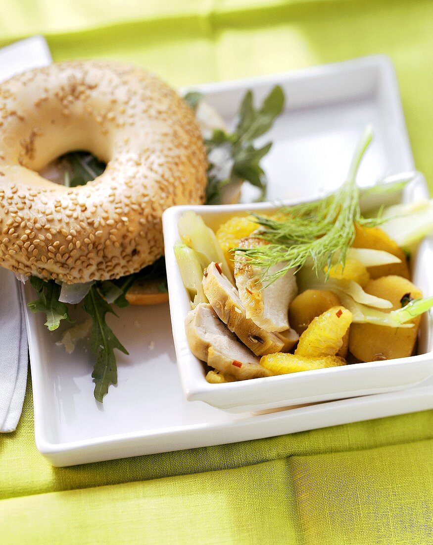 Chicken fillet with fennel and oranges; bagel with rocket