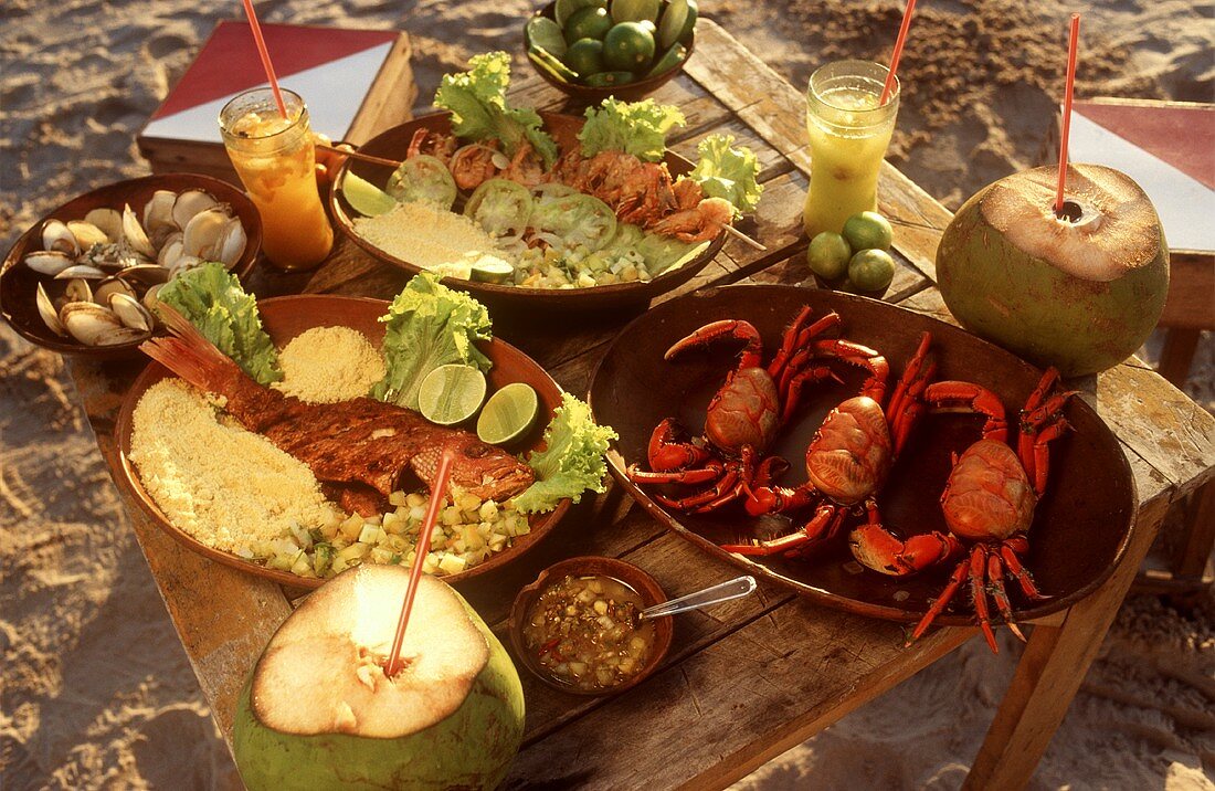Fish and seafood dishes with drinks on beach