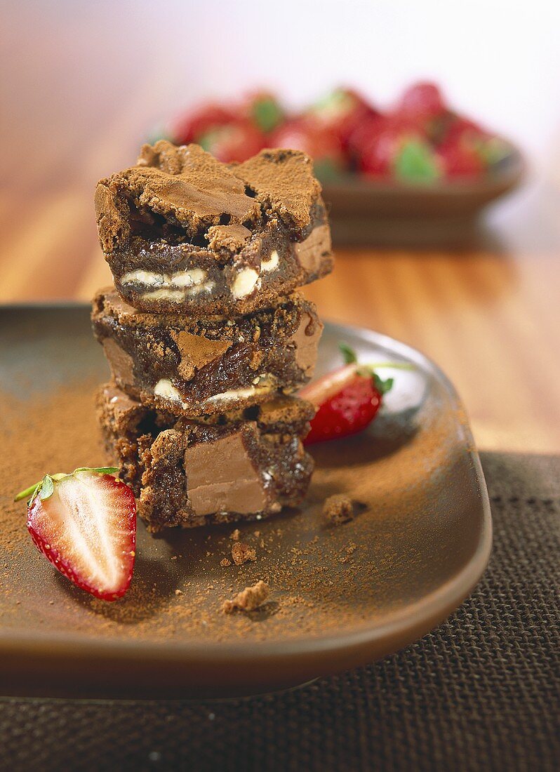 Brownies in a pile with strawberries