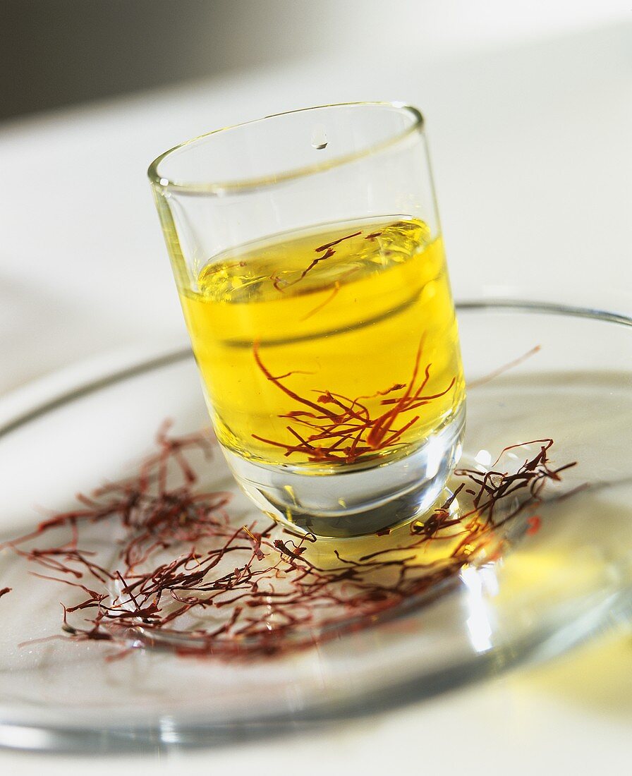 Saffron threads on a plate and in a water glass
