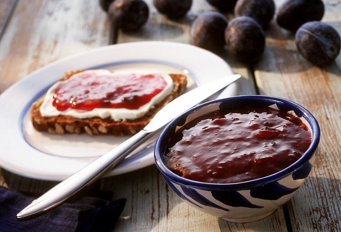 Plum puree in bowl and on bread and butter