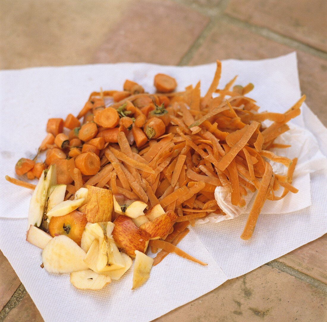 Organic waste on kitchen paper (carrot trimmings, apple peel)