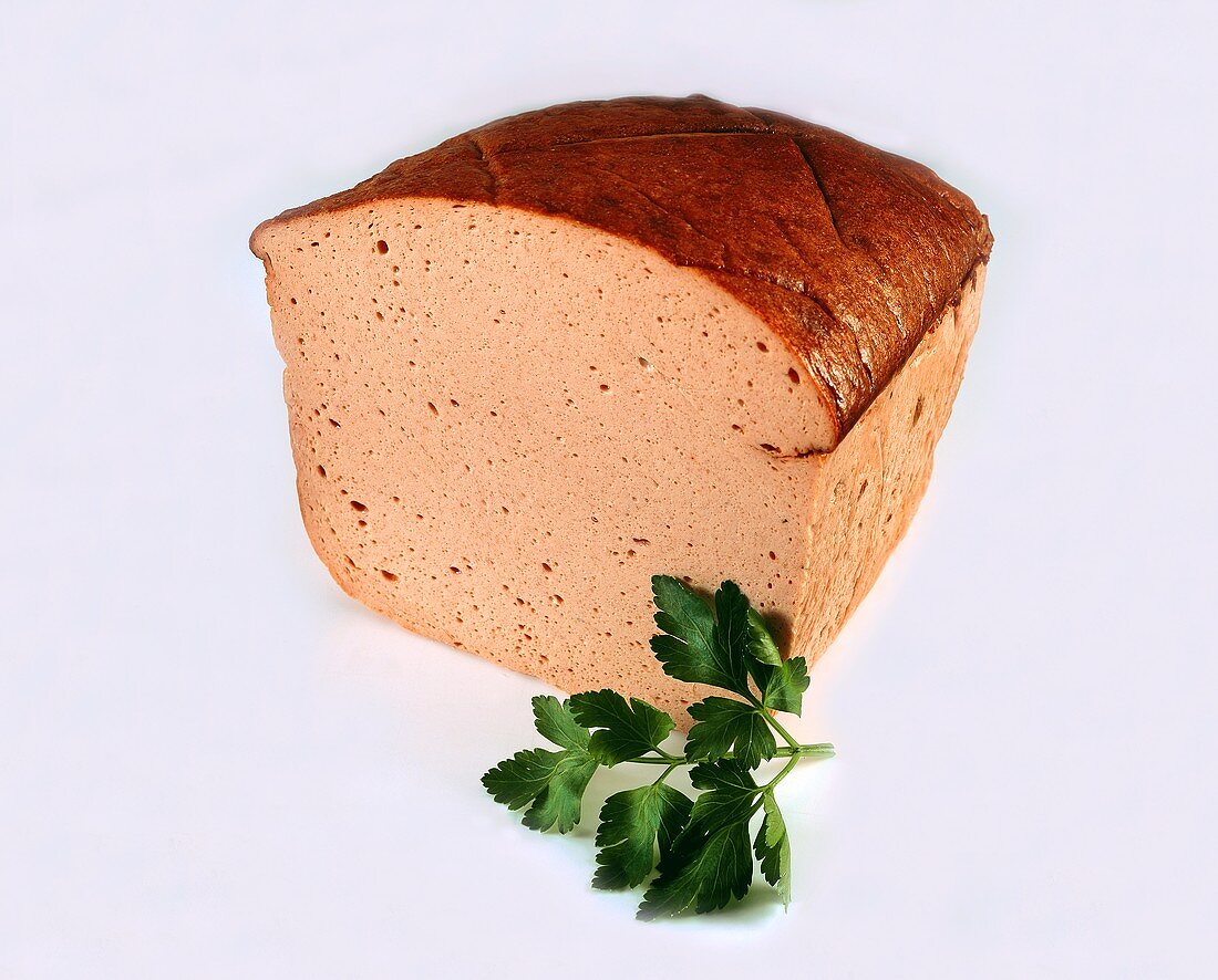 Liver cheese (meatloaf), garnished with sprig of parsley