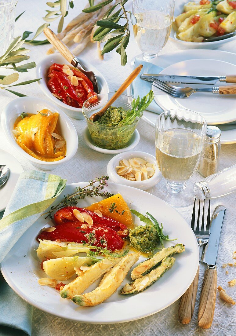 Mediterranean antipasti with almonds, pesto and white wine