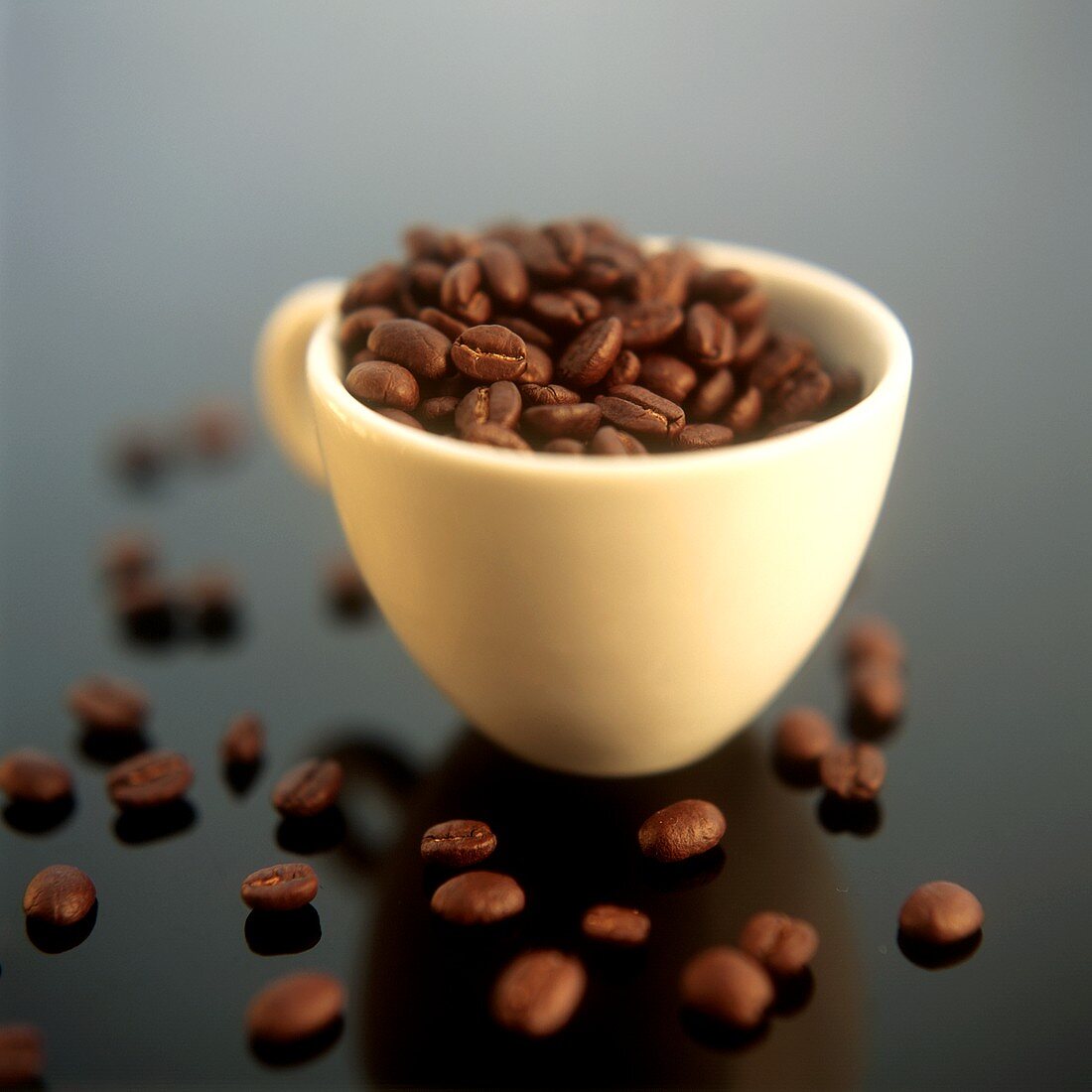 Coffee beans in yellow coffee cup