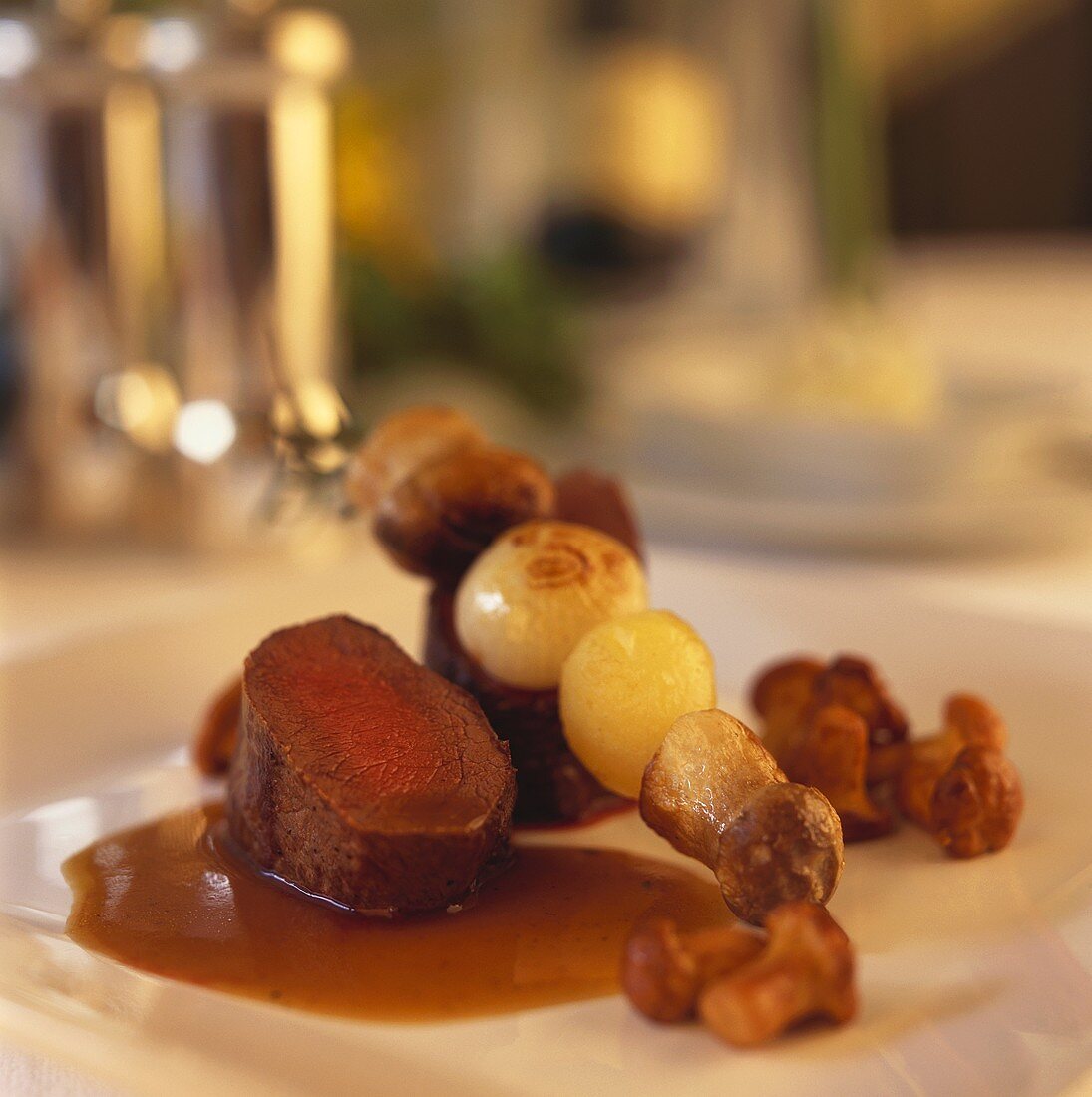 Venison medallions with chanterelles and skewered ceps