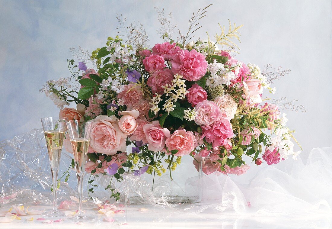 Festive bouquet of roses and meadow flowers; champagne