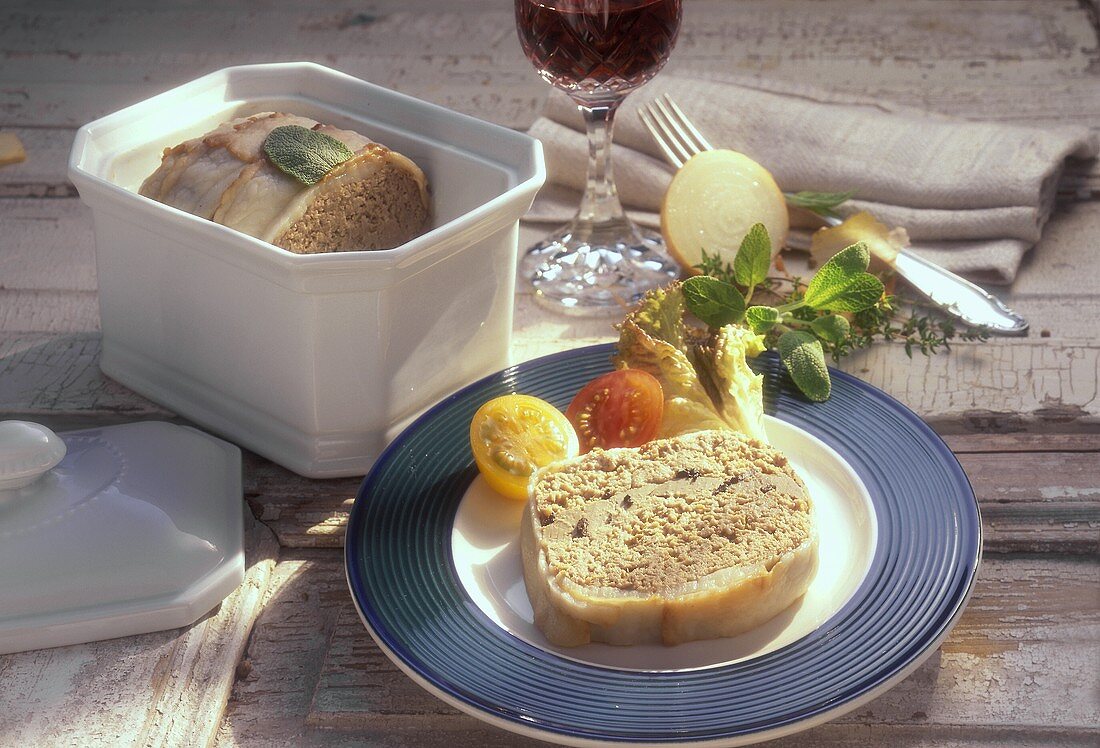 Goose liver pate in pate dish and on plate