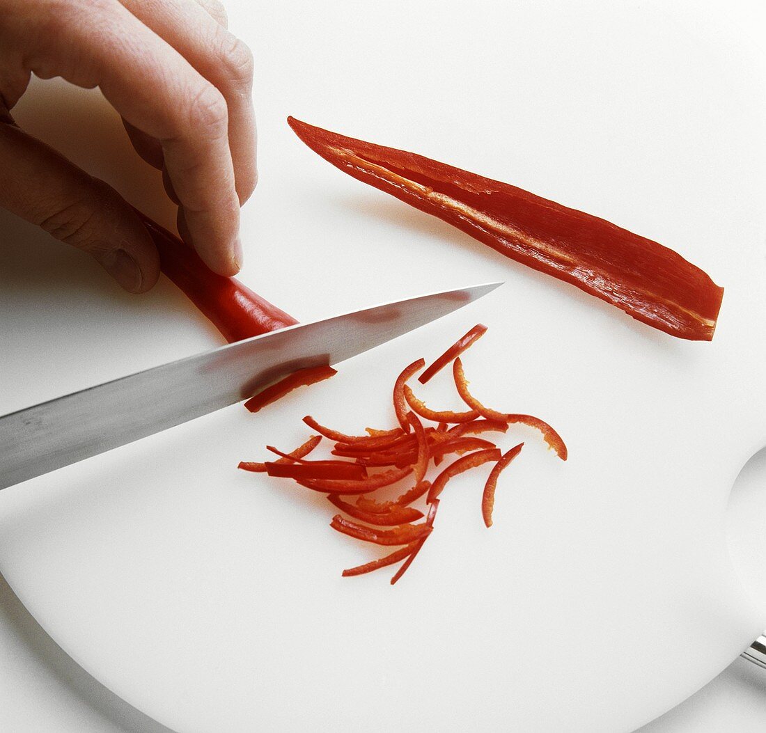 Cutting chili pepper into strips