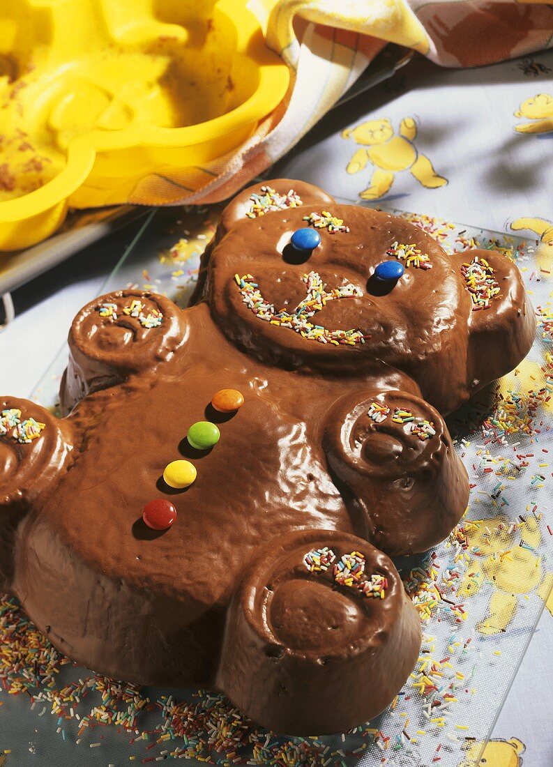 Chocolate cake in the shape of a bear with sugar sprinkles 