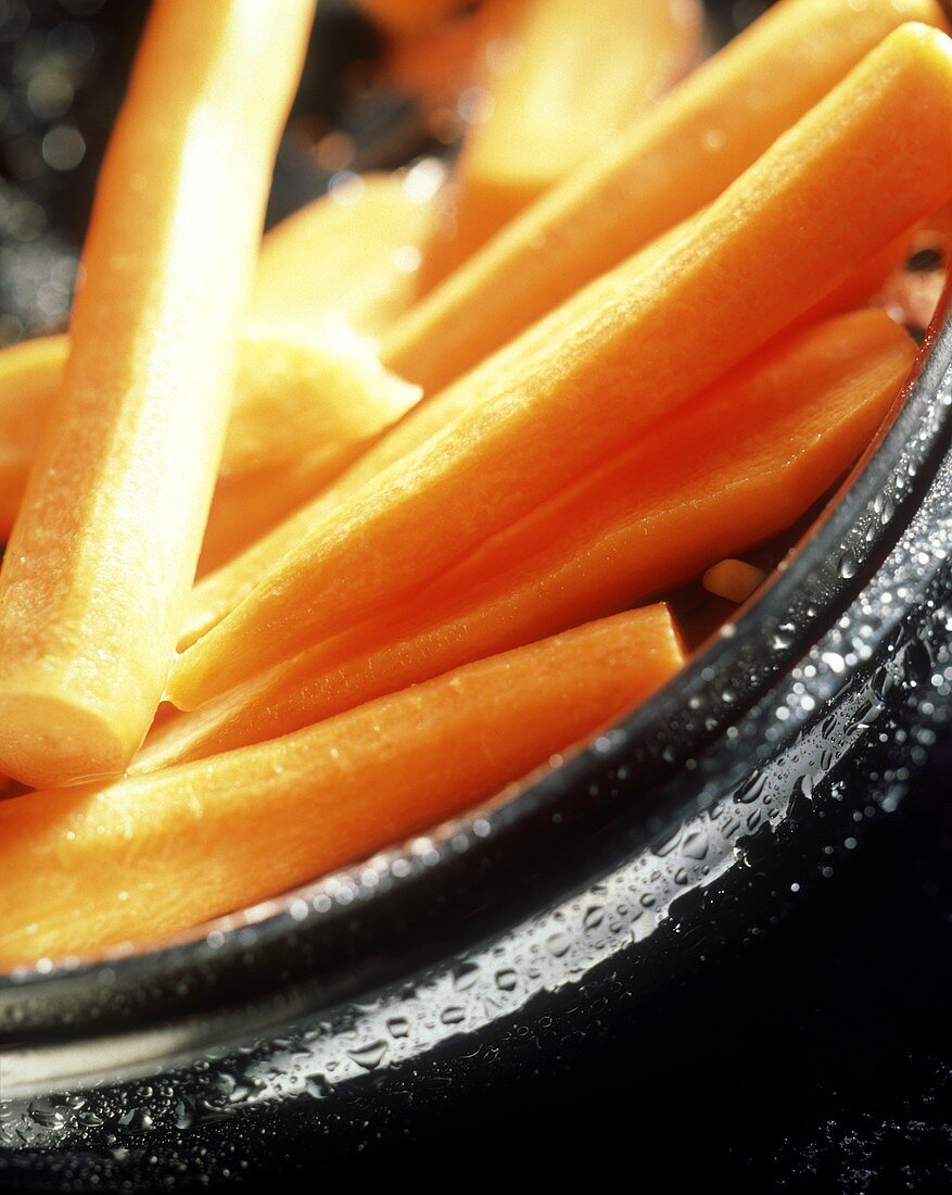 Peeled carrots in a metal dish