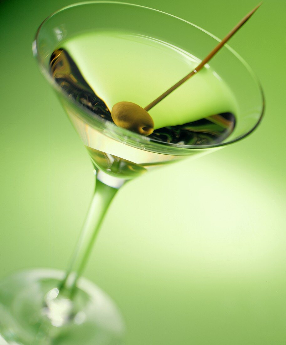 Martini with a green olive on a toothpick