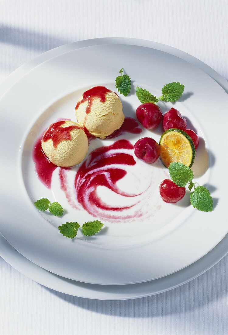 Vanilla ice cream with cherry sauce, cherries & lemon balm